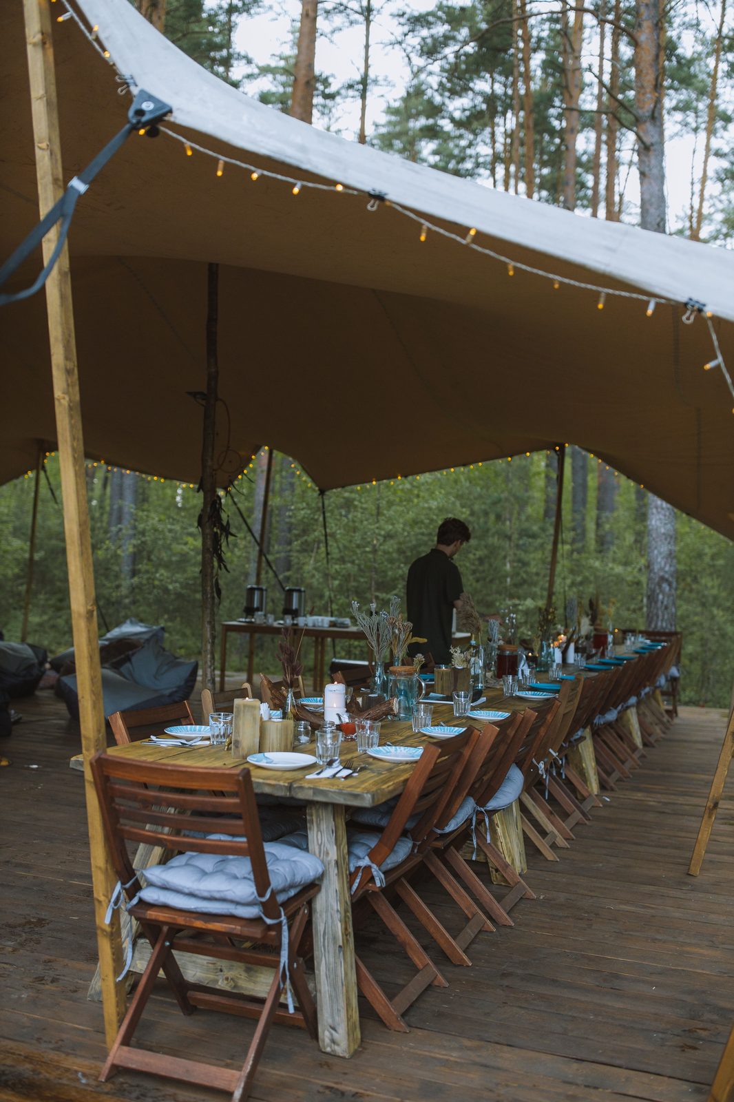 Long table dinner setup under a tent (stock photo)