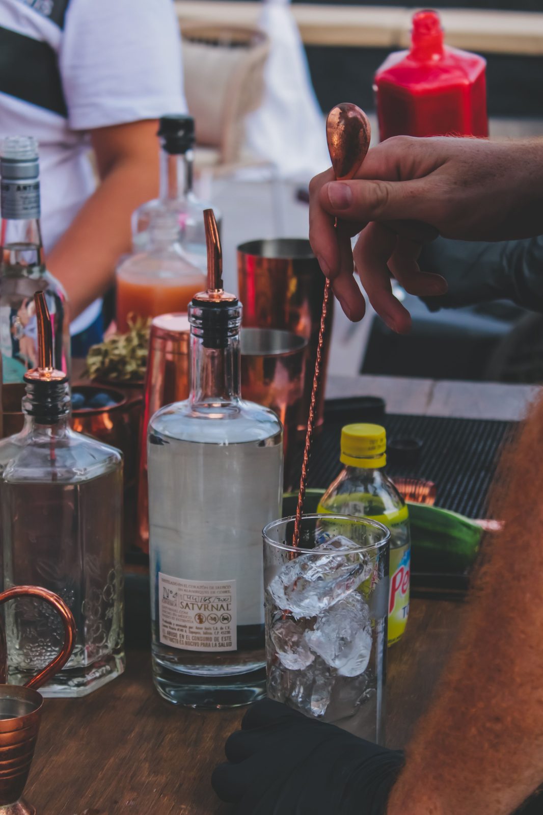 Stirring a cocktail with a copper barspoon (stock photo)