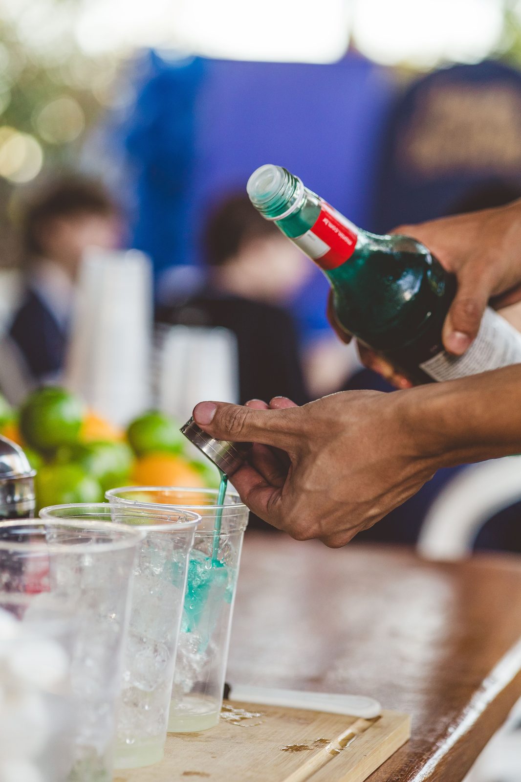 Pouring a colorful specialty cocktail outdoors (stock photo)