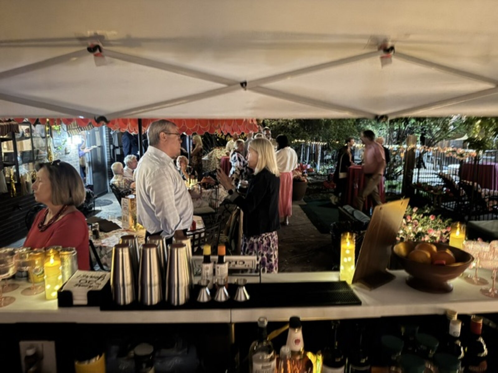 View from behind the bar with guests mingling at an evening event